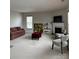 Spacious living room with a fireplace, neutral carpet, bright windows, and ample seating at 8833 Goldfields Dr, Charlotte, NC 28227