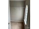 Walk-in closet with wire shelving, a unique arched window, and neutral carpet at 8833 Goldfields Dr, Charlotte, NC 28227