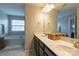 Bathroom with dual sinks, spacious countertops, dark cabinets, and soaking tub at 1019 Archibald Ave, Fort Mill, SC 29708