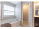 Bright bathroom featuring a soaking tub, white tile, and ample natural light at 1019 Archibald Ave, Fort Mill, SC 29708