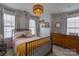 Bright bedroom featuring a comfortable bed with stylish bedding and a unique woven light fixture at 1019 Archibald Ave, Fort Mill, SC 29708