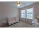 Cozy bedroom featuring a crib, neutral walls, and soft natural light, creating a peaceful and inviting space at 1019 Archibald Ave, Fort Mill, SC 29708