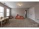Cozy bonus room features a seating area, a built in desk, and neutral colored carpet at 1019 Archibald Ave, Fort Mill, SC 29708