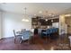 A spacious kitchen and dining area boasts dark cabinetry, stainless steel appliances, and a kitchen island with seating at 1019 Archibald Ave, Fort Mill, SC 29708
