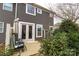 Back patio with outdoor seating area, french doors, and view of lush greenery at 1019 Archibald Ave, Fort Mill, SC 29708