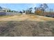 Expansive backyard featuring a storage shed and wood fence, perfect for outdoor activities at 111 Chaffee Pl, Mooresville, NC 28115