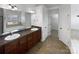 Bathroom features double sink vanity, large mirror, tub, and separate walk-in closet at 111 Chaffee Pl, Mooresville, NC 28115