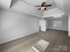 Open bedroom features a tray ceiling, ceiling fan, and carpeted floors at 111 Chaffee Pl, Mooresville, NC 28115