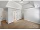 Bright bedroom featuring tray ceilings, neutral carpet, and multiple closets for ample storage at 111 Chaffee Pl, Mooresville, NC 28115