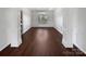Elegant dining room with wainscoting, hardwood floors, chandelier, and lots of natural light at 111 Chaffee Pl, Mooresville, NC 28115