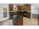 Cozy kitchen featuring an island with granite countertop and stainless steel appliances at 111 Chaffee Pl, Mooresville, NC 28115