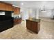 Open kitchen with granite countertops, a center island, modern appliances, and wood cabinets at 111 Chaffee Pl, Mooresville, NC 28115