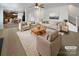 Bright living room featuring neutral furniture, a ceiling fan and open access to kitchen at 111 Chaffee Pl, Mooresville, NC 28115