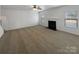 Bright living room with a fireplace, neutral carpet, ceiling fan, and plenty of natural light at 111 Chaffee Pl, Mooresville, NC 28115