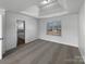 Spacious main bedroom featuring a tray ceiling, large window and neutral carpeting at 111 Chaffee Pl, Mooresville, NC 28115