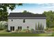 Rear exterior view features gray siding, trimmed garden beds, a sliding glass door and lush lawn at 1146 Nations Dr, Charlotte, NC 28217