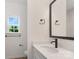 Bright bathroom featuring a white vanity with solid surface countertop and modern black hardware at 1156 Nations Dr, Charlotte, NC 28217