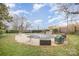 Backyard featuring a large, covered pool with surrounding patio area and outdoor furniture at 1300 Reece Rd # 200, Charlotte, NC 28209