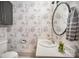 Well-lit half bath with a toilet and a decorative tree wallpaper at 1300 Reece Rd # 200, Charlotte, NC 28209