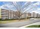 A large apartment complex with multiple balconies, showcasing its size and location near a tree-lined street at 1300 Reece Rd # 200, Charlotte, NC 28209