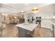 Open-concept kitchen with an island, stainless steel appliances, and bright lighting at 1300 Reece Rd # 200, Charlotte, NC 28209