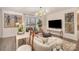 Bright living room featuring modern decor, stylish furniture, and a sliding glass door to a private balcony at 1300 Reece Rd # 200, Charlotte, NC 28209