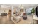 Bright living room featuring stylish furniture, modern lighting, and a sliding glass door to a private balcony at 1300 Reece Rd # 200, Charlotte, NC 28209