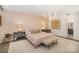 Bright main bedroom with a decorative accent wall, comfortable bed, and modern lighting at 1300 Reece Rd # 200, Charlotte, NC 28209