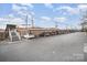 Wide shot of a long, covered parking area featuring multiple parked vehicles under a metal canopy at 1300 Reece Rd # 200, Charlotte, NC 28209