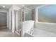 Modern bathroom featuring a glass shower and a soaking tub at 13332 Caite Ridge Rd, Davidson, NC 28036