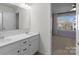 Bright bathroom with dual vanity sinks and a large mirror at 13332 Caite Ridge Rd, Davidson, NC 28036