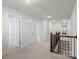 Upstairs hallway with carpet flooring, white walls, and access to multiple rooms at 13332 Caite Ridge Rd, Davidson, NC 28036