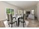 This view shows a dining room table with seating and an open floor plan into the living room at 1413 Windy Park Dr, Stanley, NC 28164