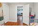 Hallway view into a bedroom featuring hardwood floors and an open doorway at 148 Linwood Dr, Albemarle, NC 28001