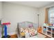 Well-lit bedroom features a crib, toys, and hardwood floors at 148 Linwood Dr, Albemarle, NC 28001