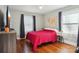 Bright bedroom features hardwood floors, ample natural light, and tasteful decor at 148 Linwood Dr, Albemarle, NC 28001