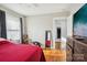 Bedroom leading to kitchen featuring hardwood floors and a modern dresser at 148 Linwood Dr, Albemarle, NC 28001