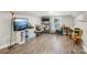 Spacious bonus room with laminate floors, storage shelves, and a TV setup at 148 Linwood Dr, Albemarle, NC 28001