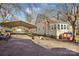 A home with a carport, manicured lawn, and mature trees on a well-kept property at 148 Linwood Dr, Albemarle, NC 28001