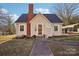 Charming cottage-style home with a brick chimney, quaint front yard, and inviting walkway at 148 Linwood Dr, Albemarle, NC 28001