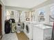 Convenient laundry room with a washer, dryer, freezer, and multiple windows providing natural light at 148 Linwood Dr, Albemarle, NC 28001
