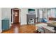 Inviting living room featuring hardwood floors, a painted fireplace, a comfortable sofa, and natural light at 148 Linwood Dr, Albemarle, NC 28001