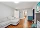 Comfortable living room with a sectional sofa, hardwood floors, view to playroom and fireplace at 148 Linwood Dr, Albemarle, NC 28001