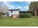 This well-maintained backyard features a deck, lush grass, and established landscaping at 1498 Oakridge Farm Hwy, Mooresville, NC 28115