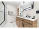 Double sink vanity, marble floors, glass shower with black hardware and a towel rack at 1498 Oakridge Farm Hwy, Mooresville, NC 28115
