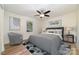 Cozy bedroom with a large bed, ceiling fan, neutral colors, and wood floors at 1498 Oakridge Farm Hwy, Mooresville, NC 28115