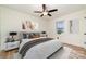 Bright bedroom with large window, ceiling fan, brown bedding and wood-look flooring at 1498 Oakridge Farm Hwy, Mooresville, NC 28115