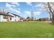 Wide expanse of lawn in front of home with renovated white facade and black trim at 1498 Oakridge Farm Hwy, Mooresville, NC 28115