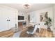 Home office features a modern desk, doors to the backyard, and wood floors at 1498 Oakridge Farm Hwy, Mooresville, NC 28115