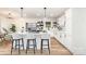 Modern kitchen with island, stainless steel appliances, white cabinetry, and hardwood floors at 1498 Oakridge Farm Hwy, Mooresville, NC 28115